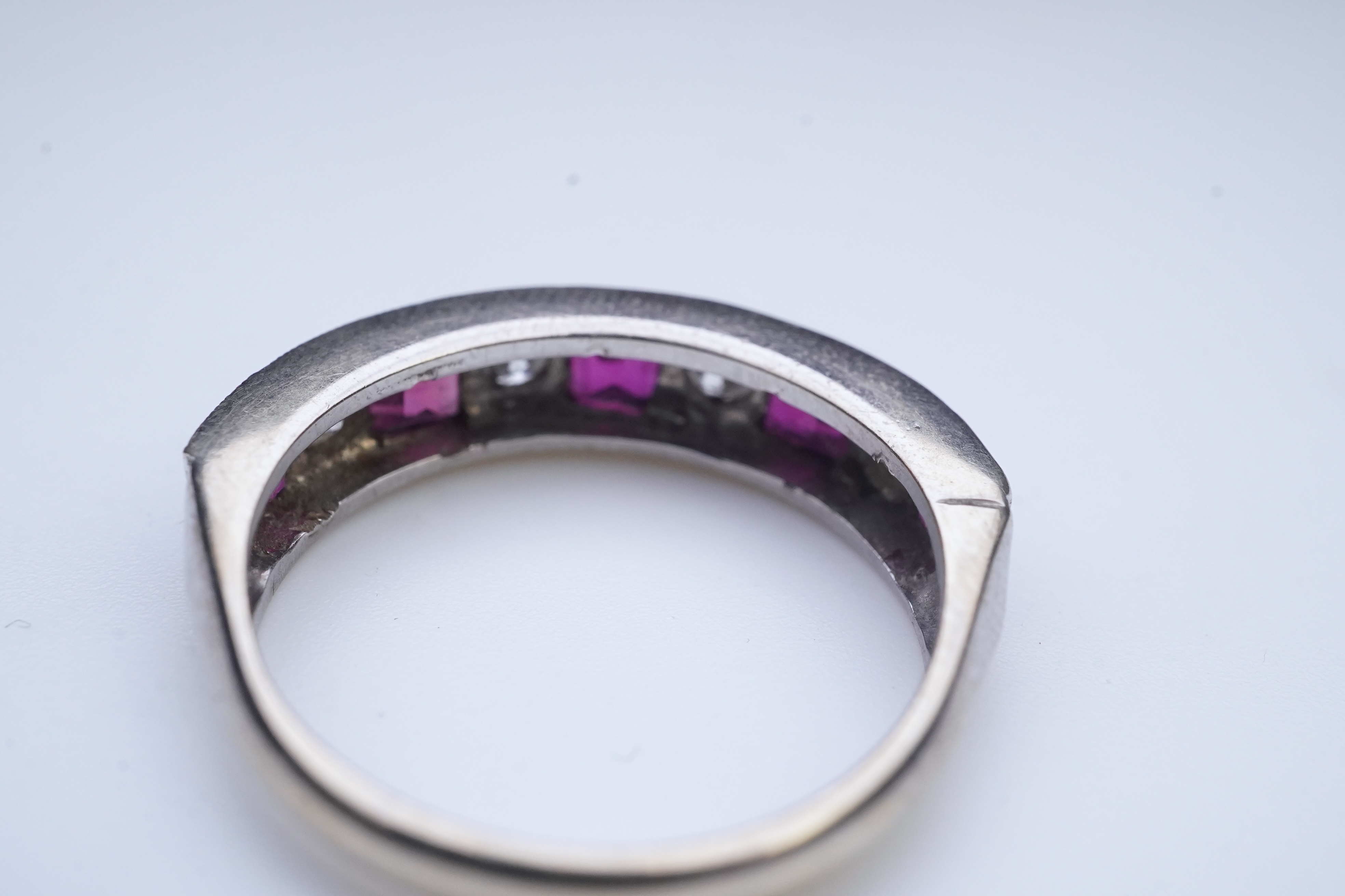 A ruby and diamond half eternity ring